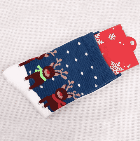 A pair of white socks with reindeer in the snow image
